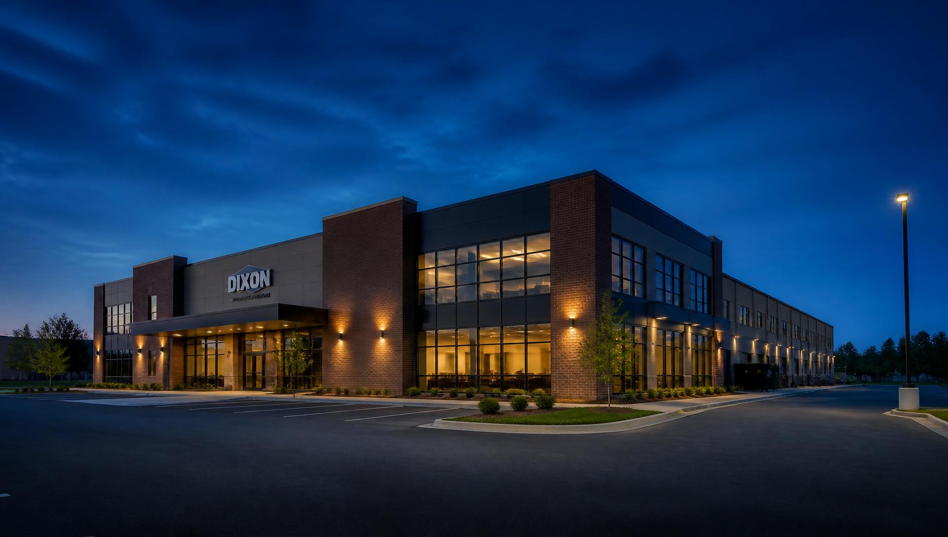Commercial property at dusk with lit interior offices